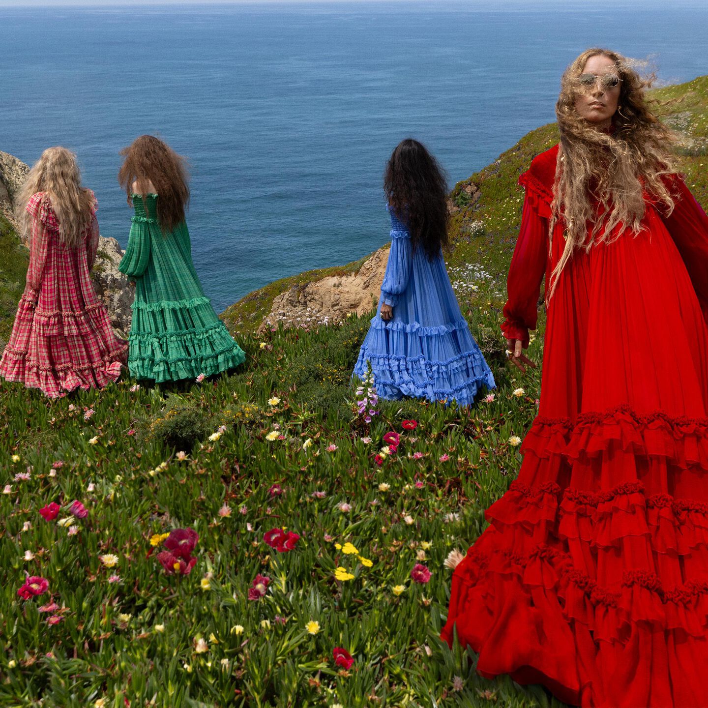 Model Raquel Zimmerman wearing a red silk dress for Winter 26 campaign